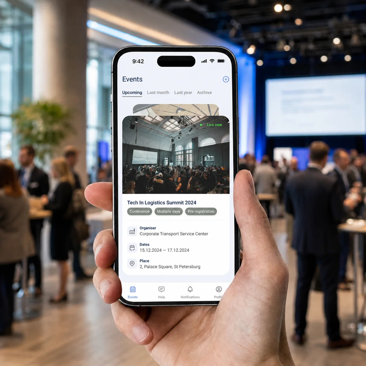 The events app held at a conference: a live event with its organiser, dates and venue, above a tab bar.